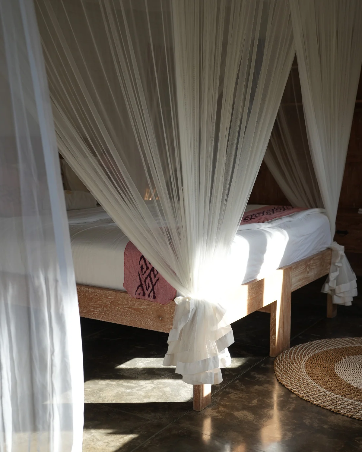 Sunlight through the sheer net of a canopy bed